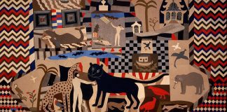 image of the quilt, red, blue and brown in colour with a men depicted with animals 
