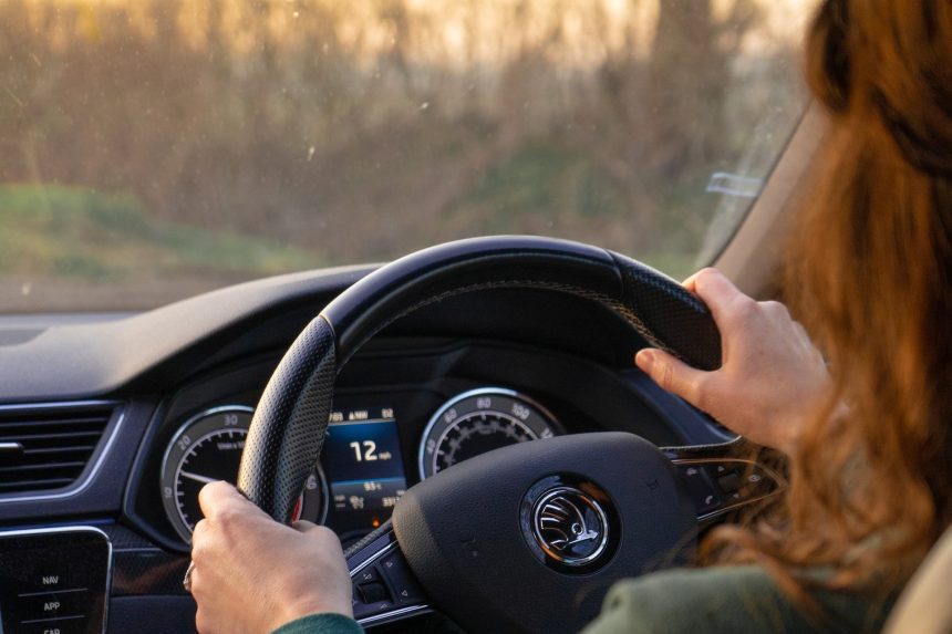 Image shows someone driving a car