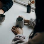 Two people chatting over a cup of coffee