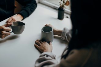 Two people chatting over a cup of coffee