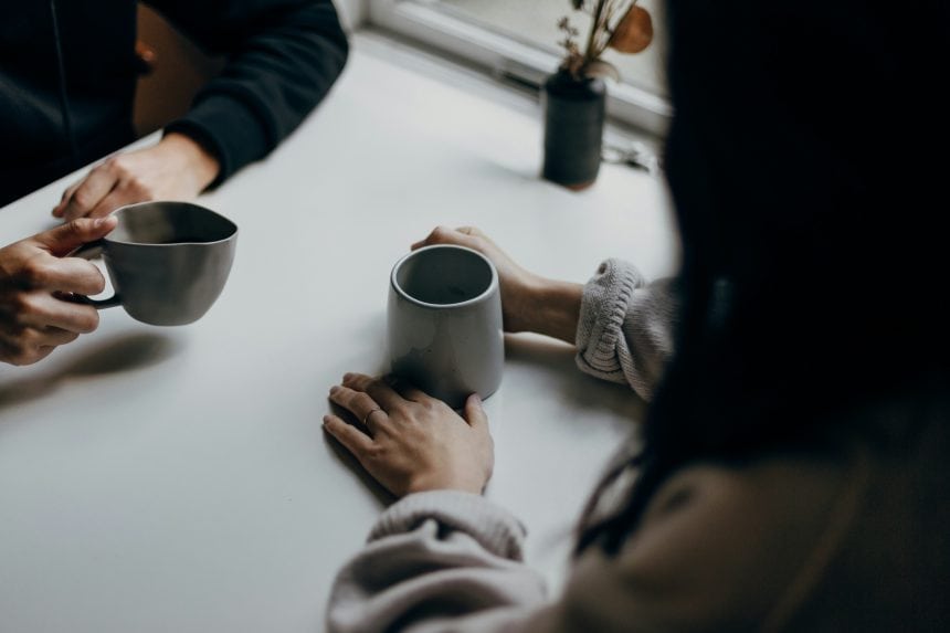 Two people chatting over a cup of coffee