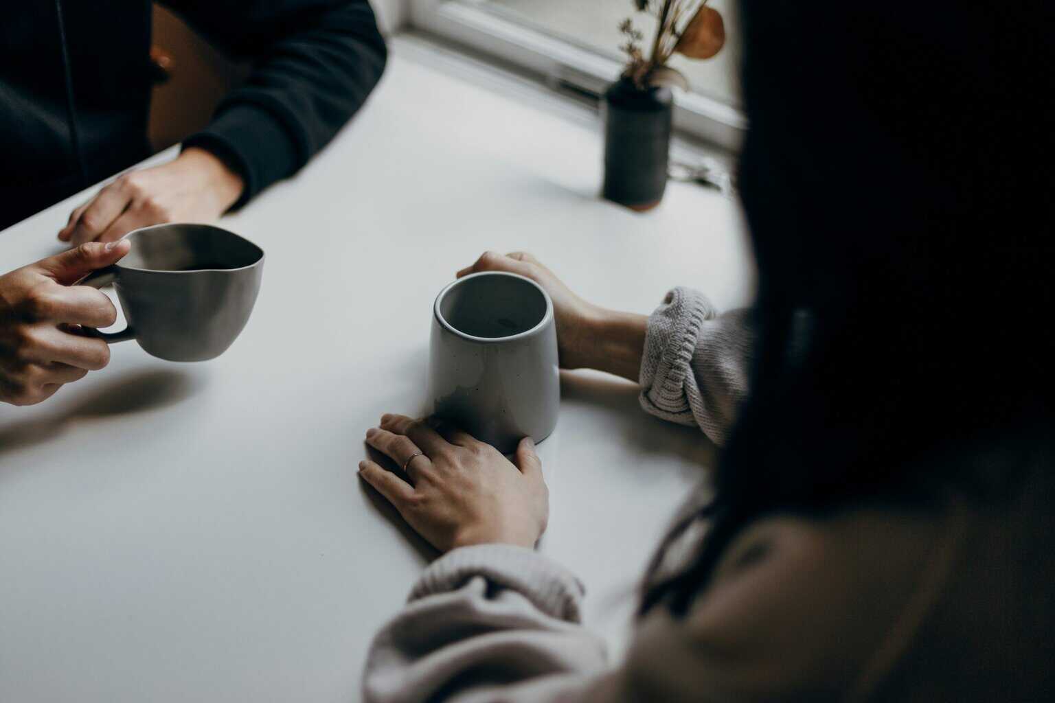 Two people chatting over a cup of coffee
