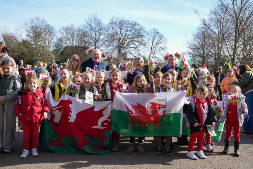 Image from St David's Day Parade of group of children holding a Welsh flag